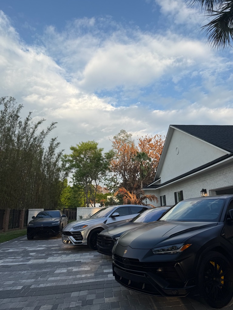 Three Lamborghini Urus SUVs detailed in an Orlando, FL driveway by Shadow Mobile Detailing & Ceramic Coating
